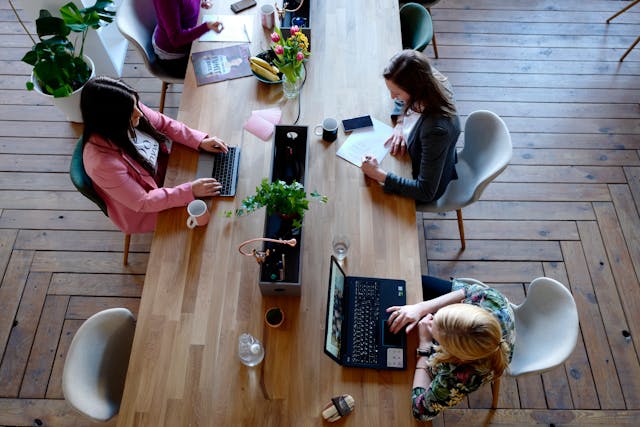 people working at large table